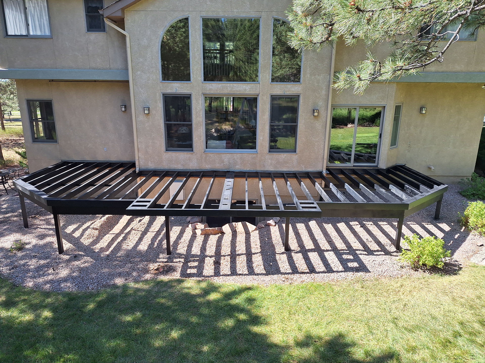 A finished steel frame deck structure connected to a house. 