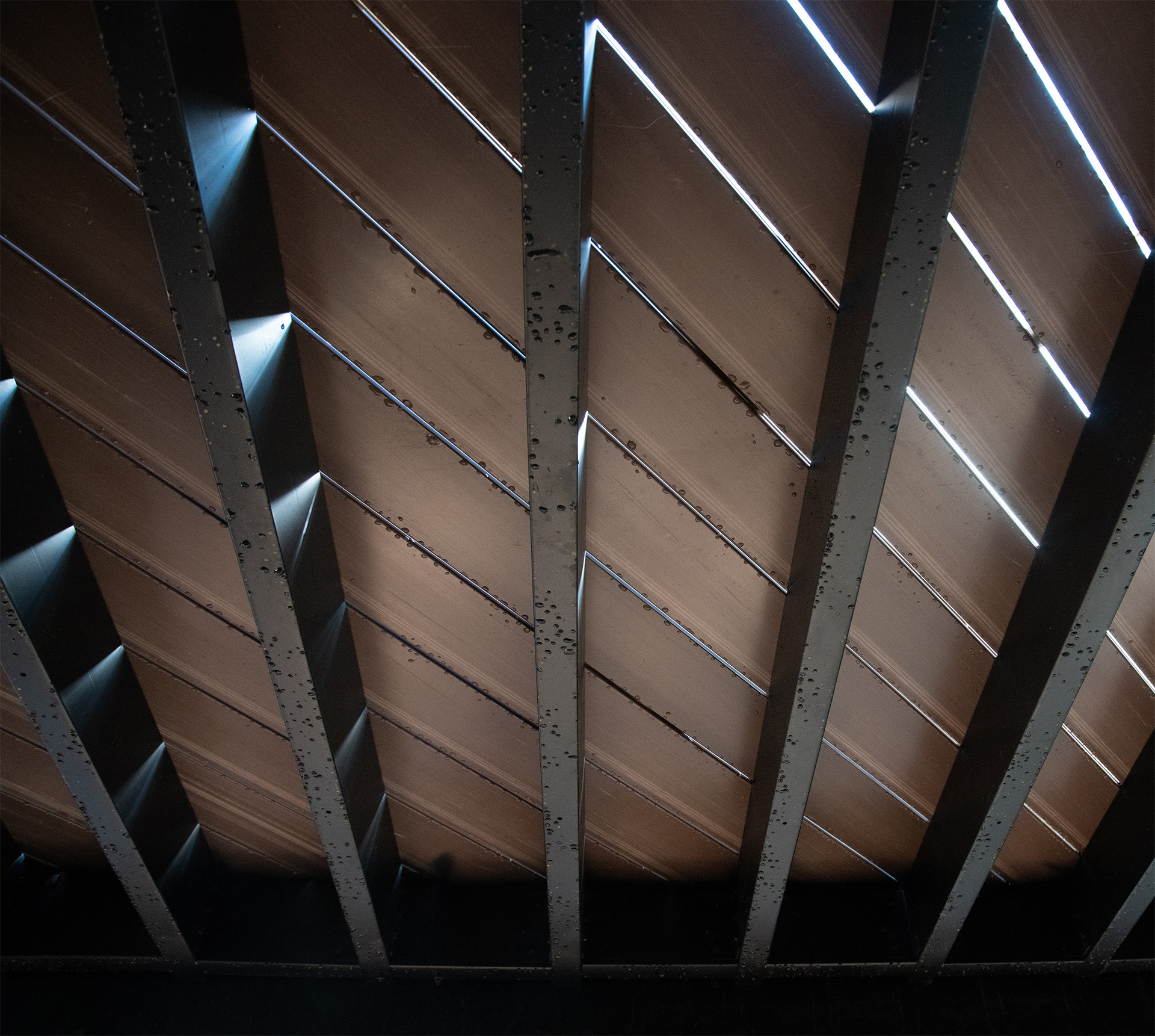 Ceiling perspective featuring wooden beams, emphasizing the structural integrity of durable deck and steel deck framing.