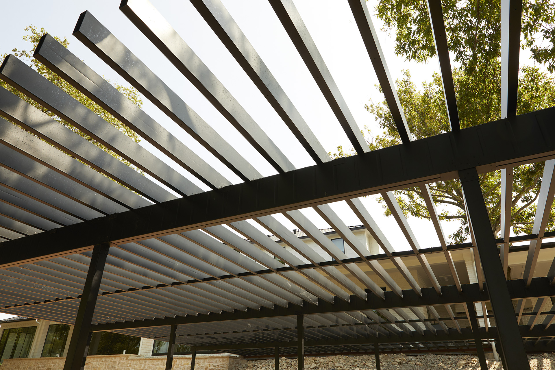 A sturdy metal roof atop a building highlights the use of steel deck framing for a durable deck structure.