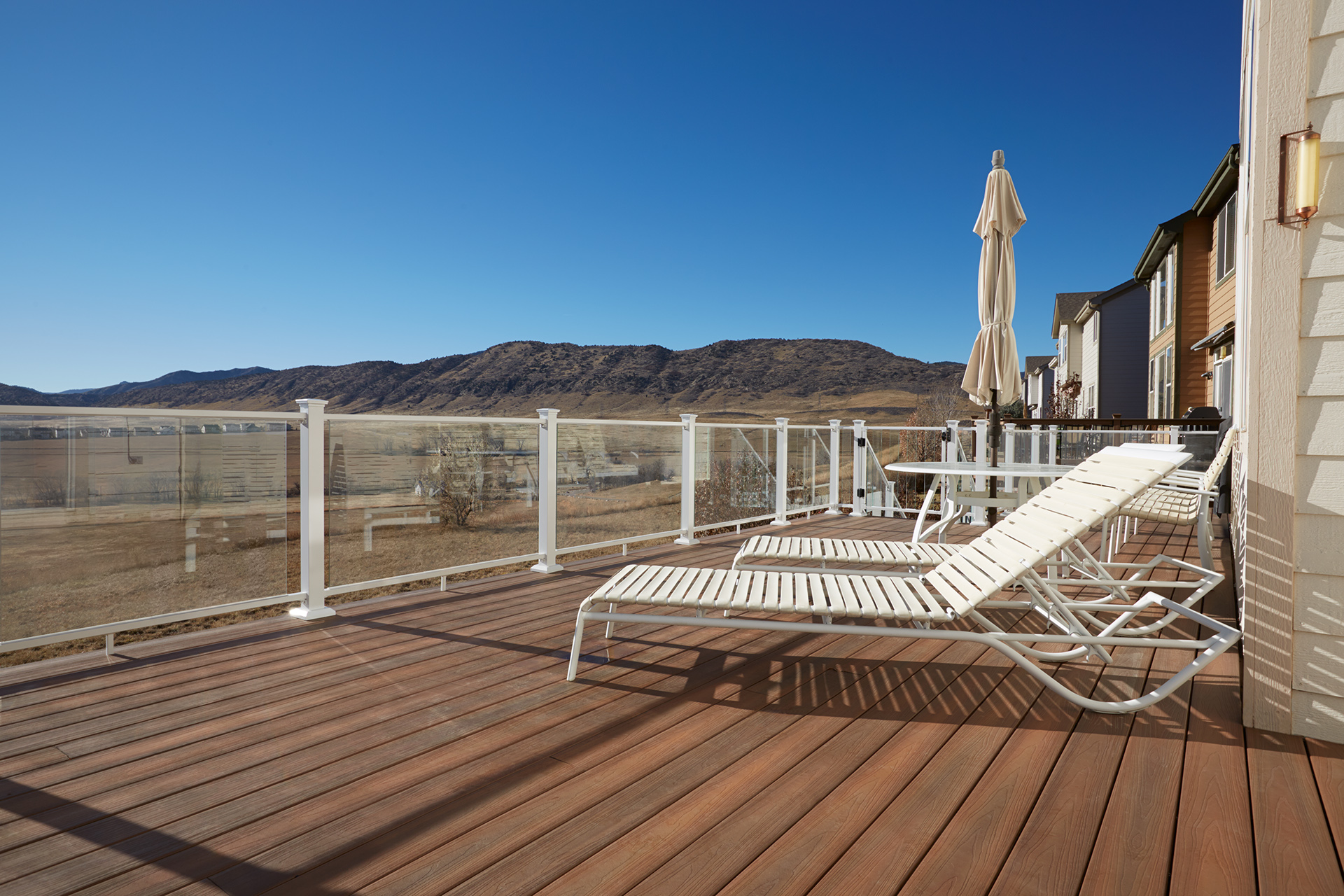 Balcony with glass railing panels extending the space and providing wind protection.