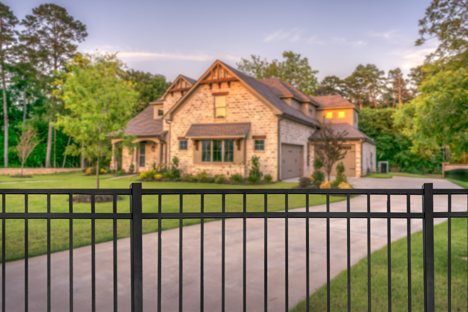 Aluminum fence surrounding a contemporary home.