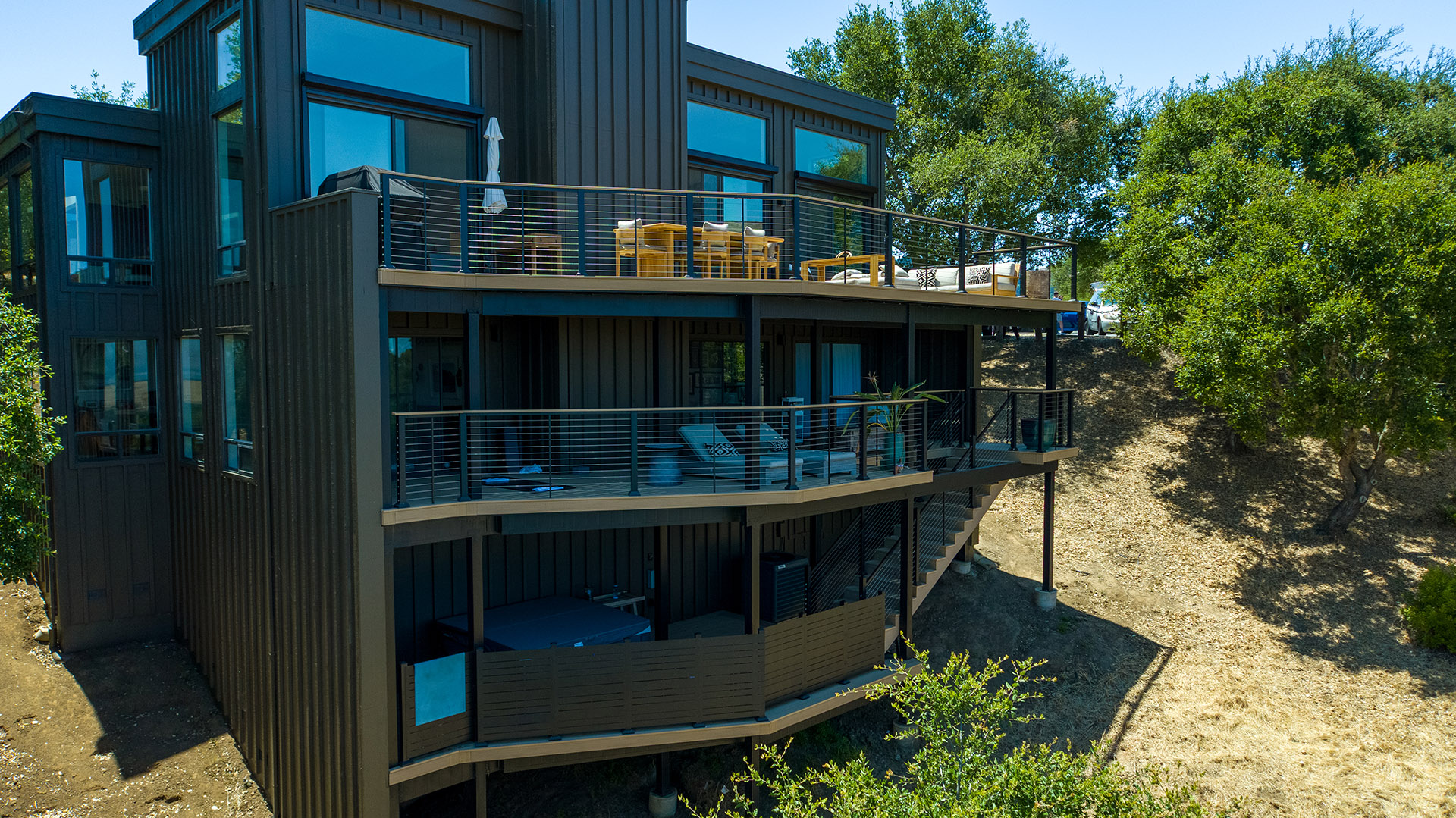 Contemporary home with tiered Fortress deck system and sleek cable railing design.