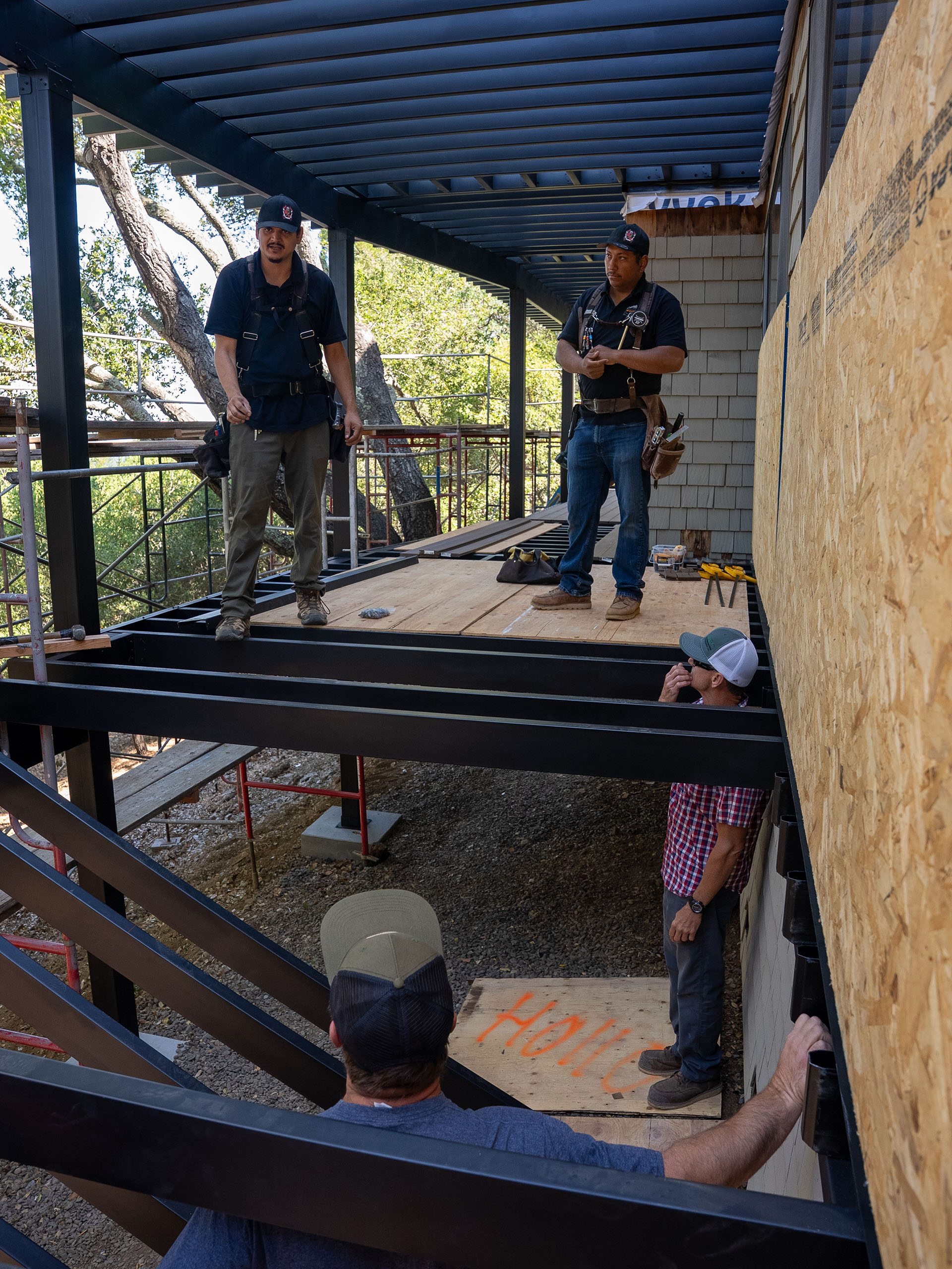 Fortress framing system under construction with crew coordinating across upper and lower deck levels.