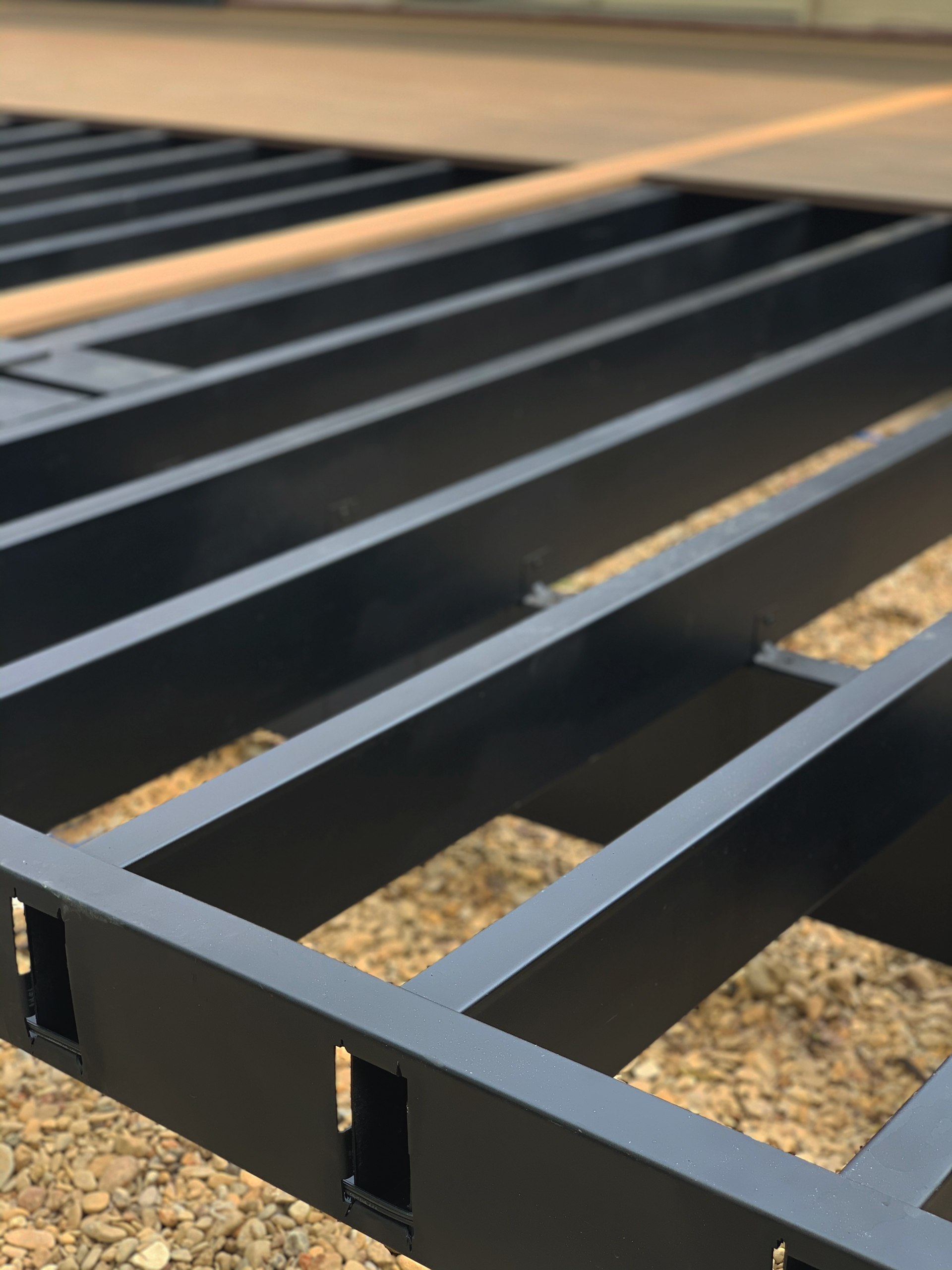 Close up of black steel deck framing in progress of being built.