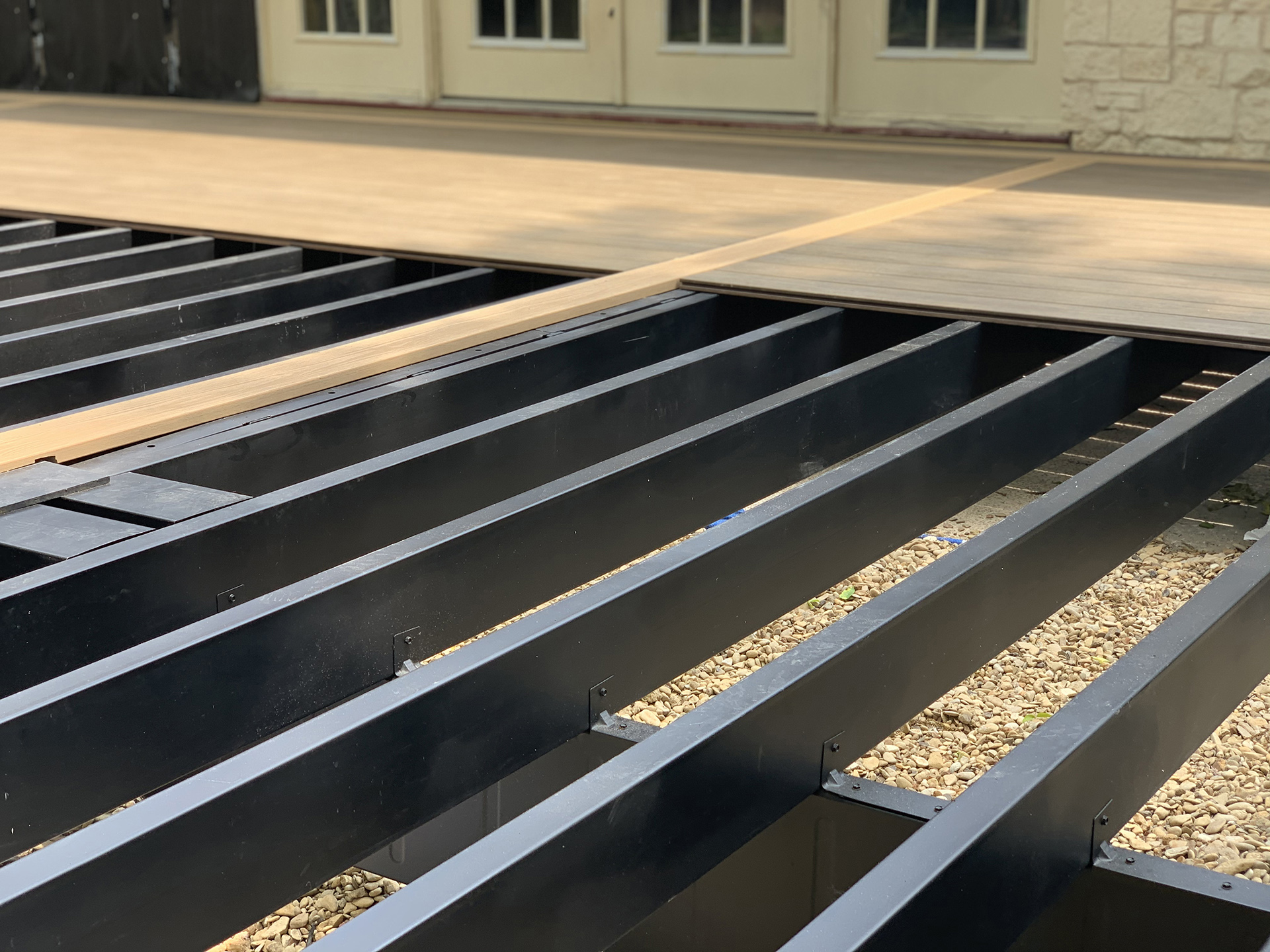 A steel deck framing system with composite decking partially installed.