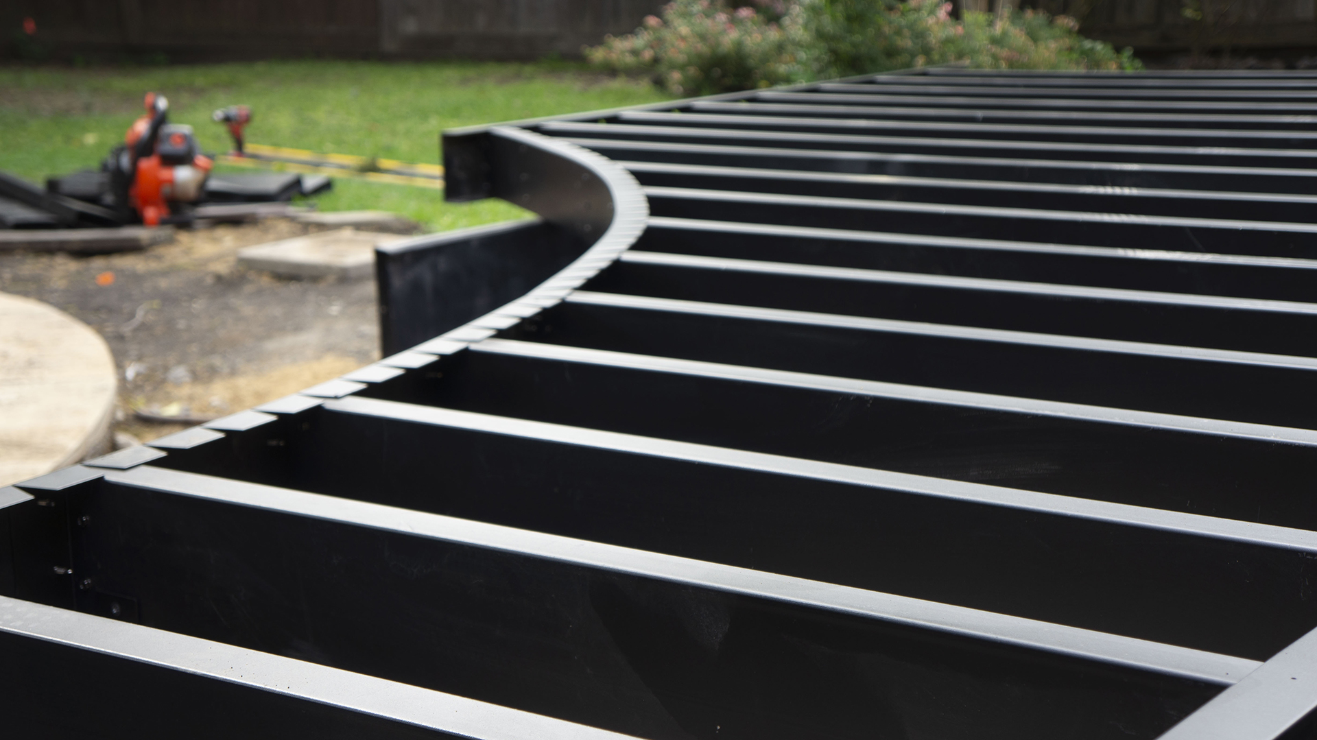 Close-up view of curved steel deck framing.