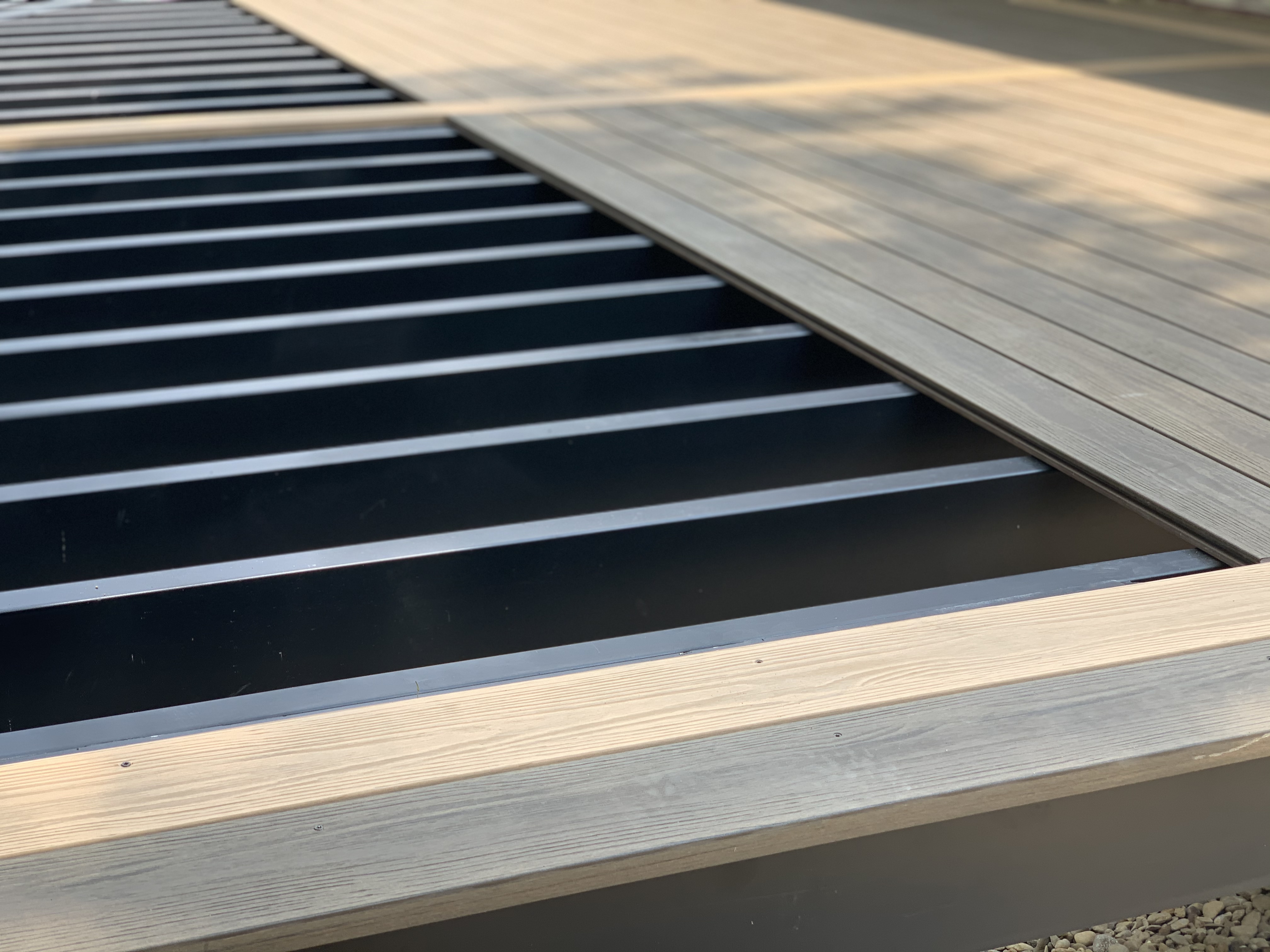A deck featuring a steel framing system with metal grills, showcasing durable construction and modern design.