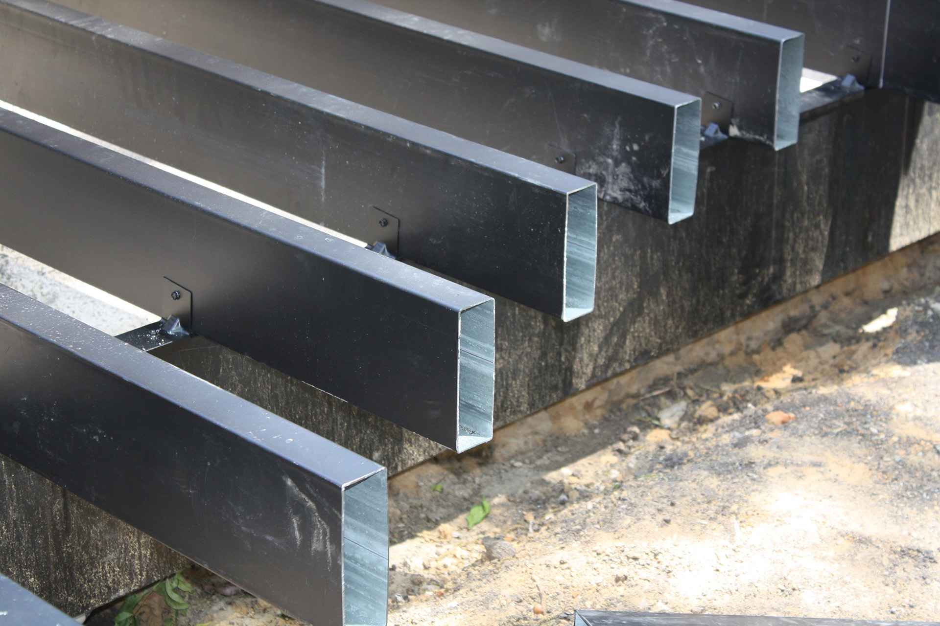 End view of powder-coated steel joists in a deck frame.