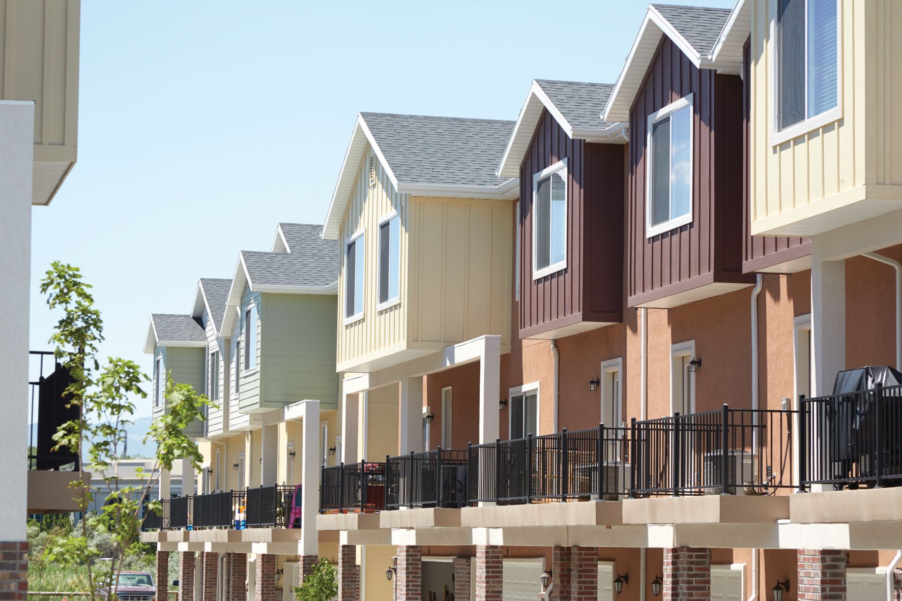 Townhouse complex with caried color schemes featuring steel railings on balconies for safety and design