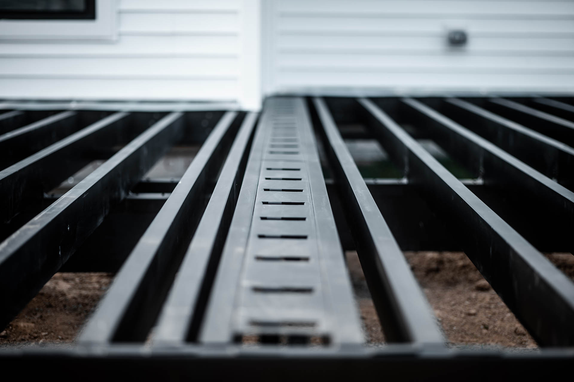 Steel deck framing installed for a lake house, showcasing clean lines and robust support.
