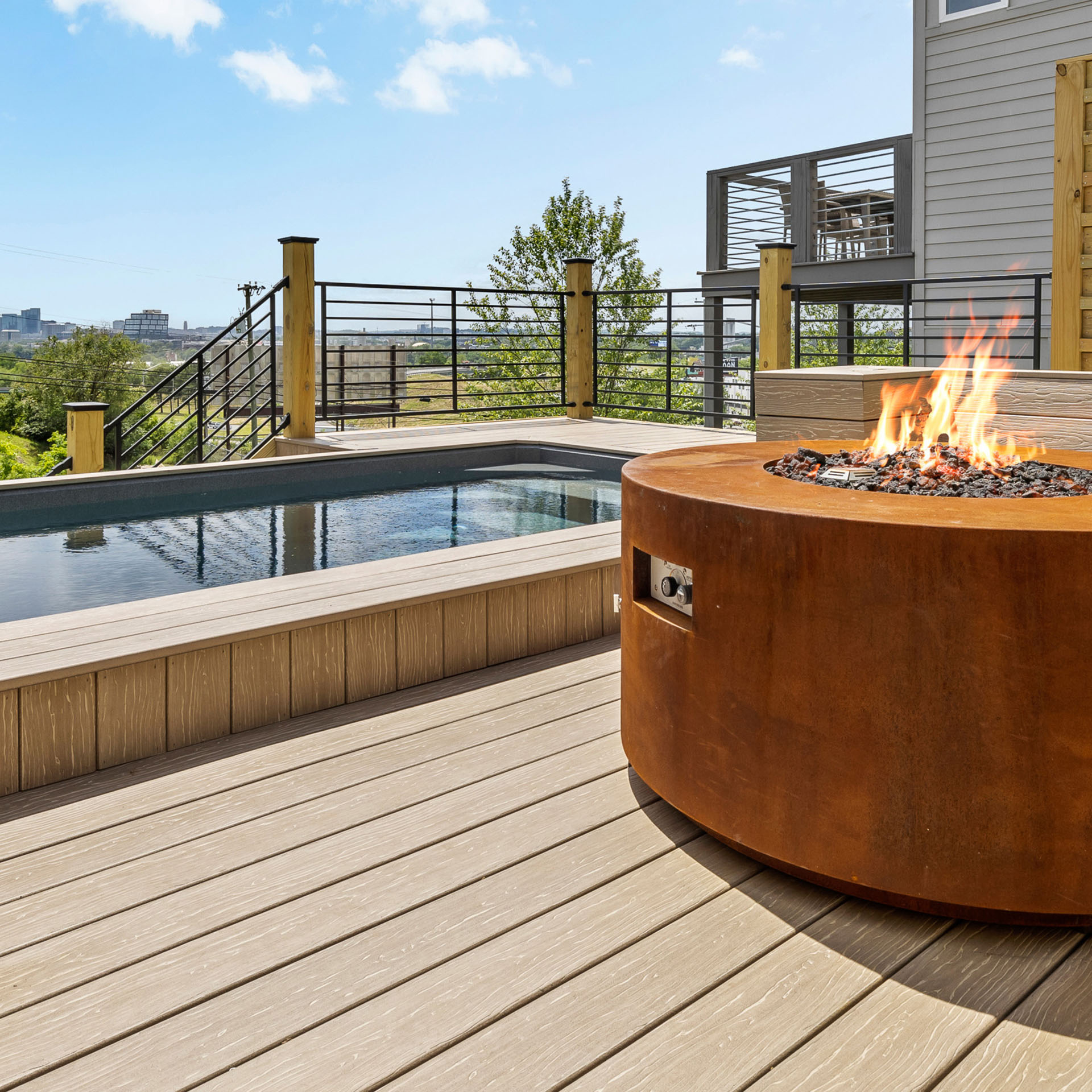 Modern weatherproof deck featuring horizontal steel railing.