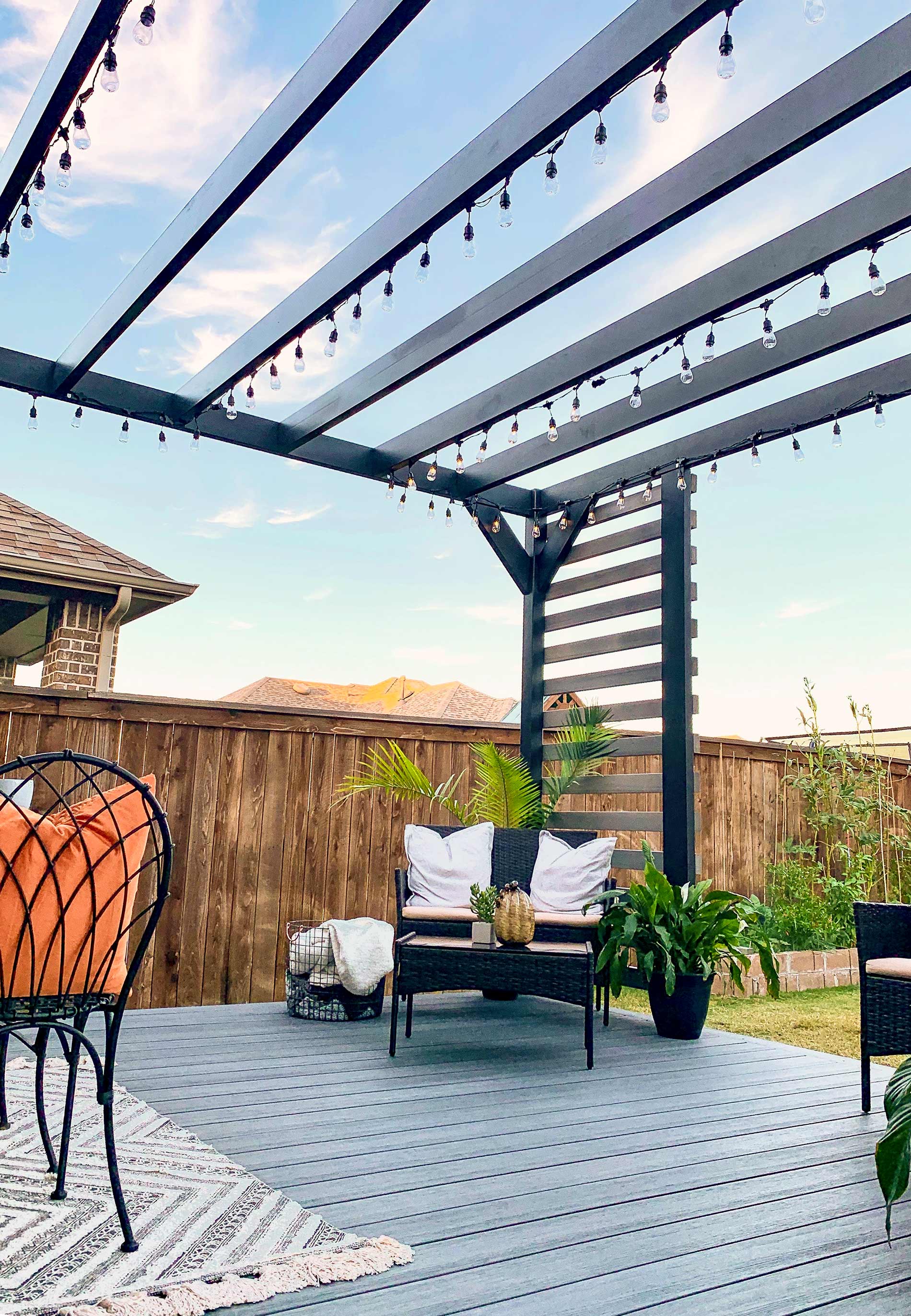 A cozy patio showcasing a fire-resistant pergola and chairs, perfect for enjoying outdoor moments safely.