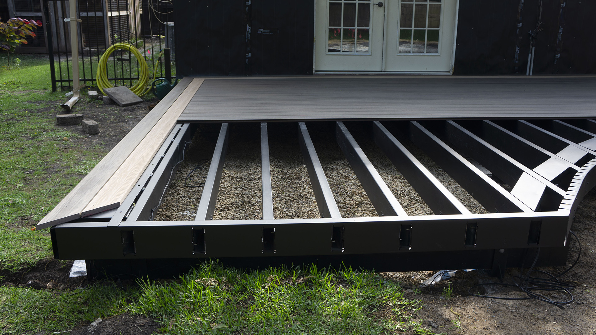 Partially installed composite decking over a steel frame.