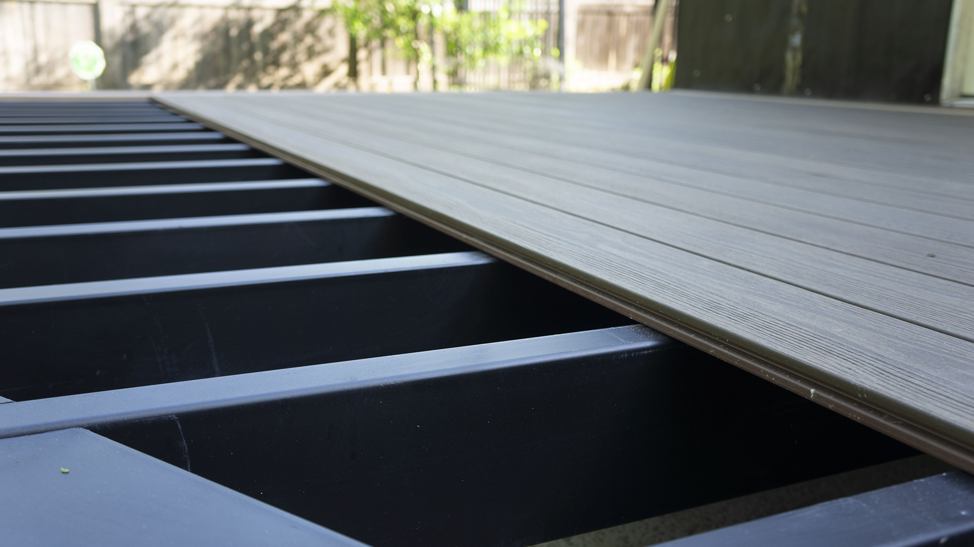 Close-up view of steel deck framing being installed for a durable and fire-safe outdoor space.