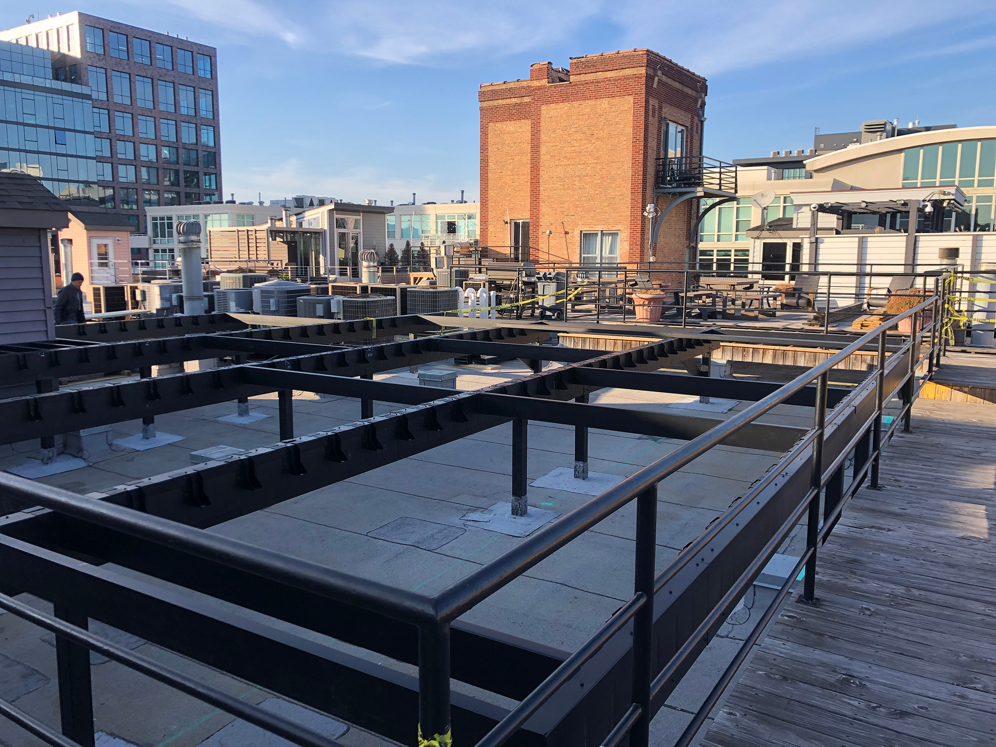 A rooftop deck featuring a metal railing, designed to be fireproof and weatherproof for outdoor use.